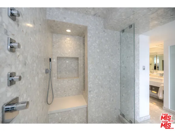 a bathroom with a glass shower door