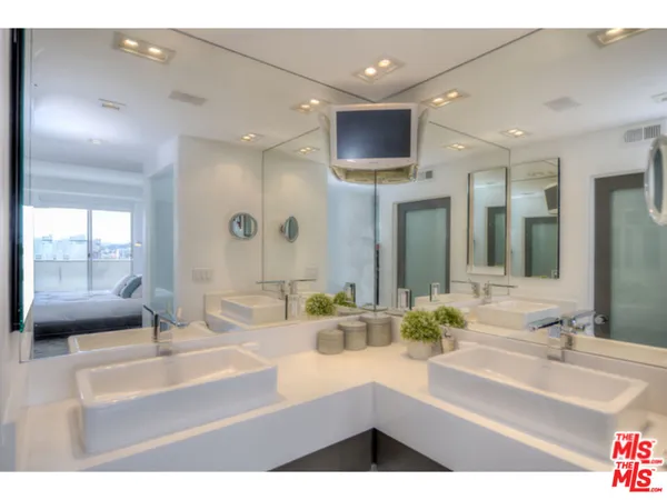 a bathroom with a sink double vanity and a mirror