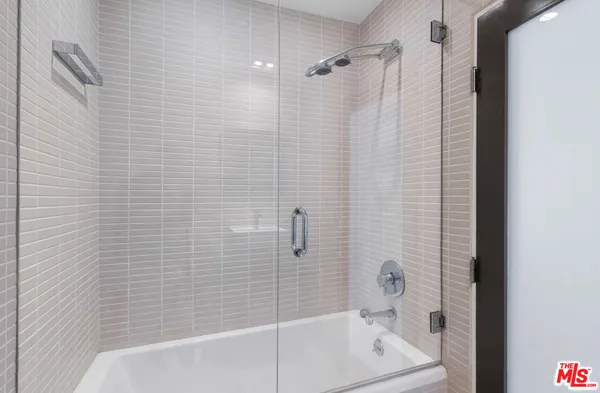 a bathroom with a shower and a bath tub