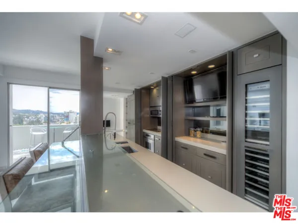 a living room with a flat screen tv and floor to ceiling window