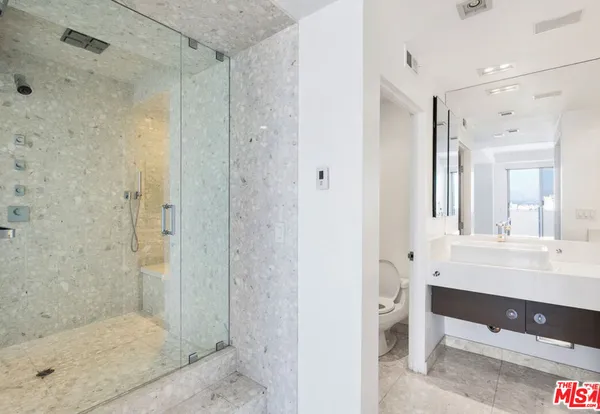 a bathroom with a shower and a sink