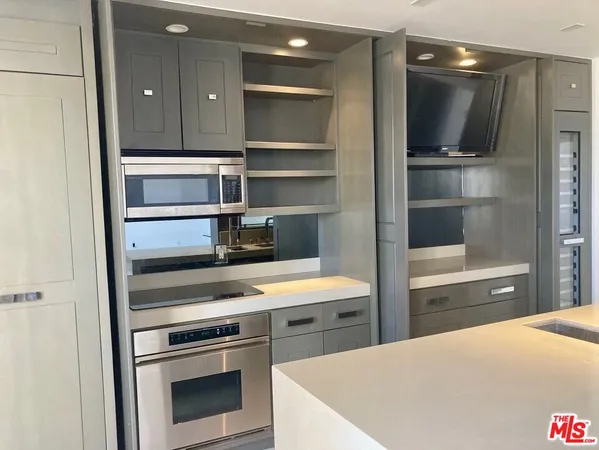 a kitchen with a stove and a refrigerator
