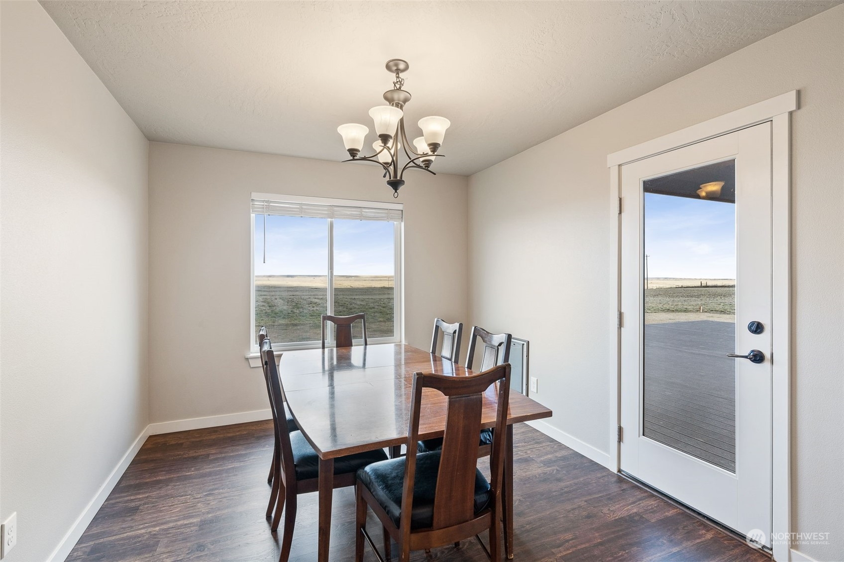 1003 North Klein Road Ritzville, WA 99169 - Photo 7 of 34 a view of a dining room with furniture a chandelier and wooden floor