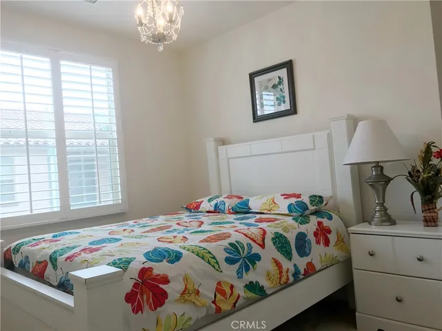 a bedroom that has a bed and a dresser in it
