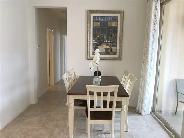 a dining room with furniture and window