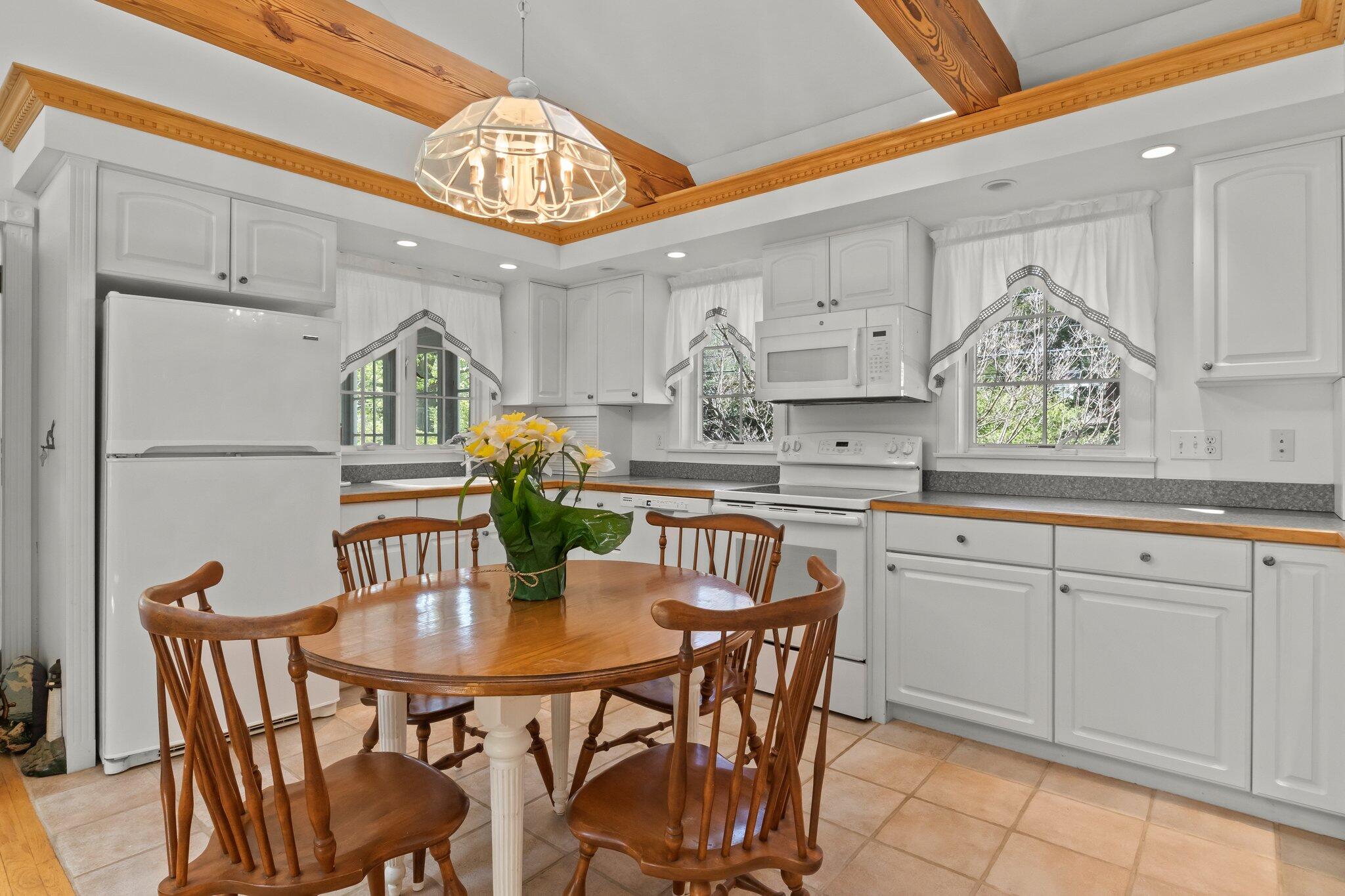 35 Hamblen Farm Road Wellfleet, MA 02667 - Photo 19 of 62 a kitchen with stainless steel appliances a table chairs and a refrigerator