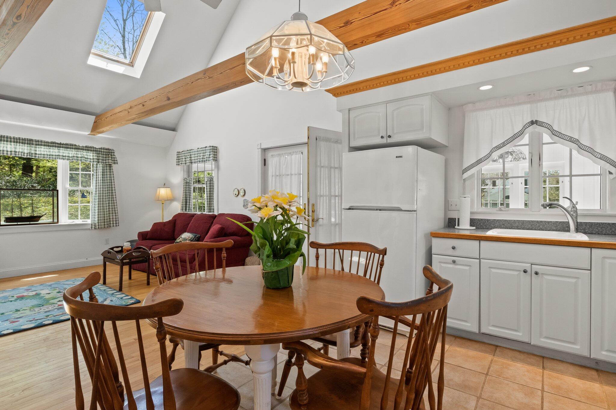 35 Hamblen Farm Road Wellfleet, MA 02667 - Photo 21 of 62 a view of a dining room with furniture and a chandelier