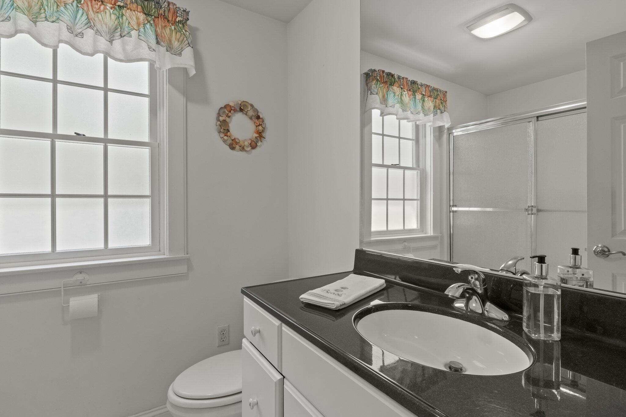 35 Hamblen Farm Road Wellfleet, MA 02667 - Photo 43 of 62 a bathroom with a granite countertop sink toilet and mirror