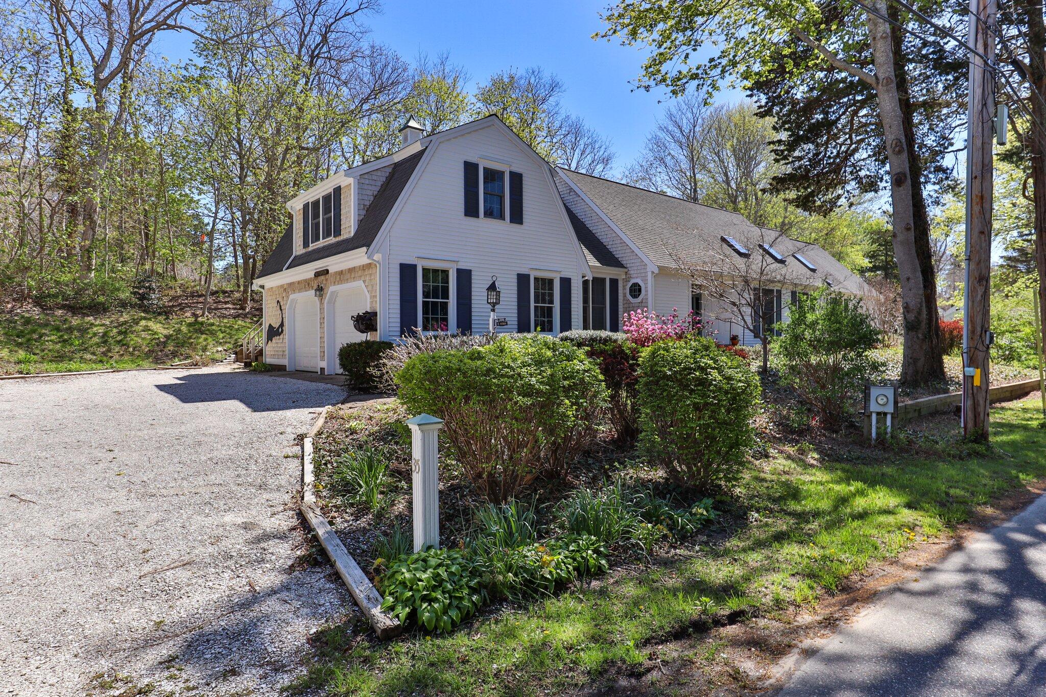 35 Hamblen Farm Road Wellfleet, MA 02667 - Photo 5 of 62 a front view of a house with a yard and large trees