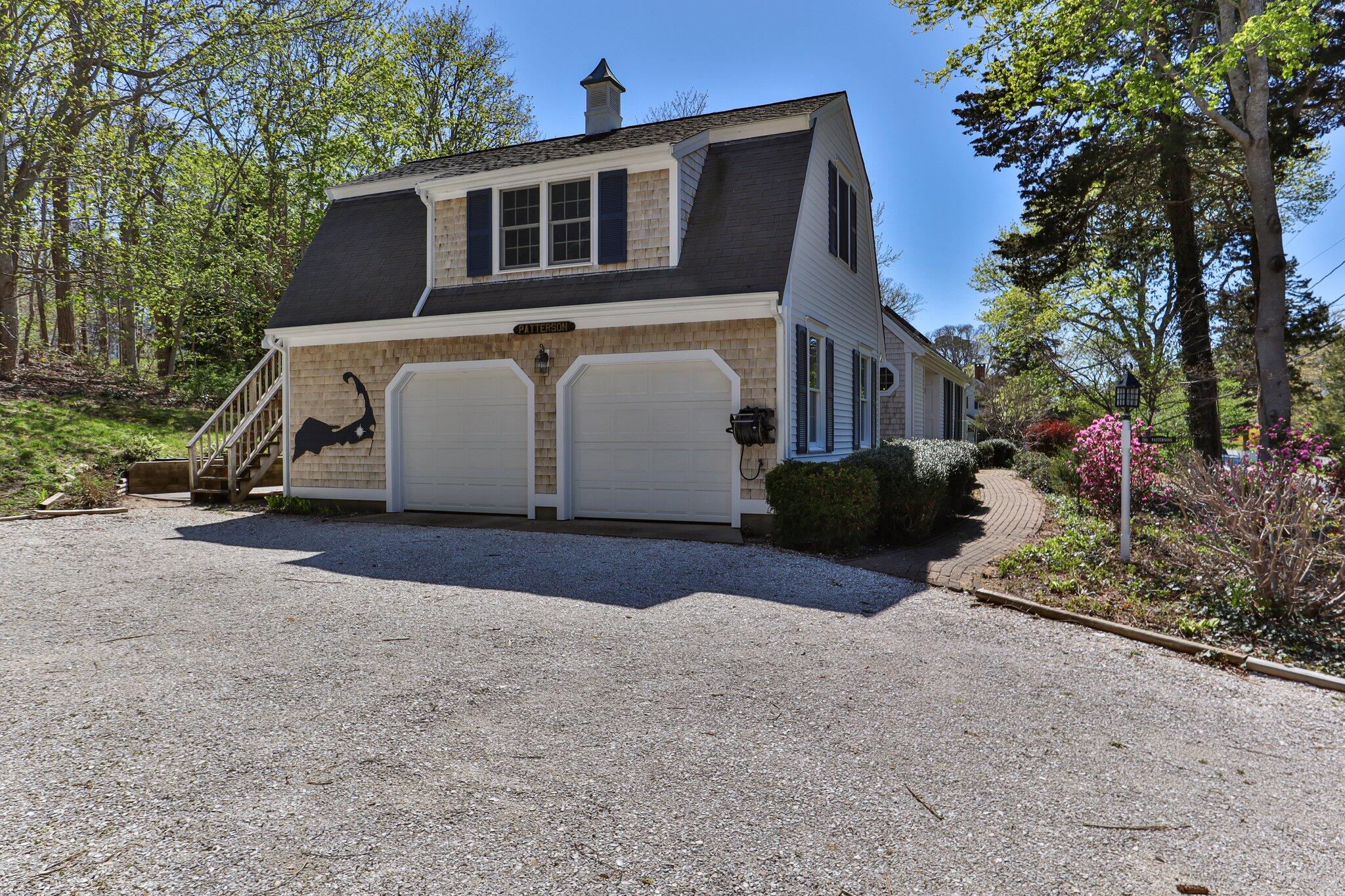 35 Hamblen Farm Road Wellfleet, MA 02667 - Photo 56 of 62 a front view of a house with a yard and garage