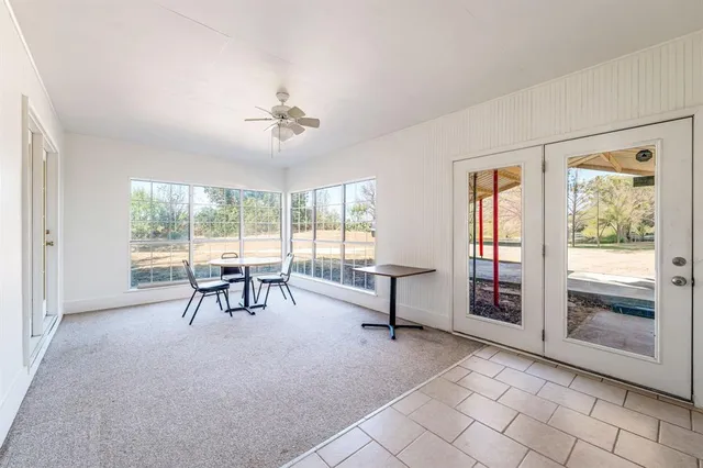 a room with a washing machine and a wooden floor