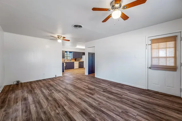 a bathroom with a granite countertop sink a toilet a mirror and shower