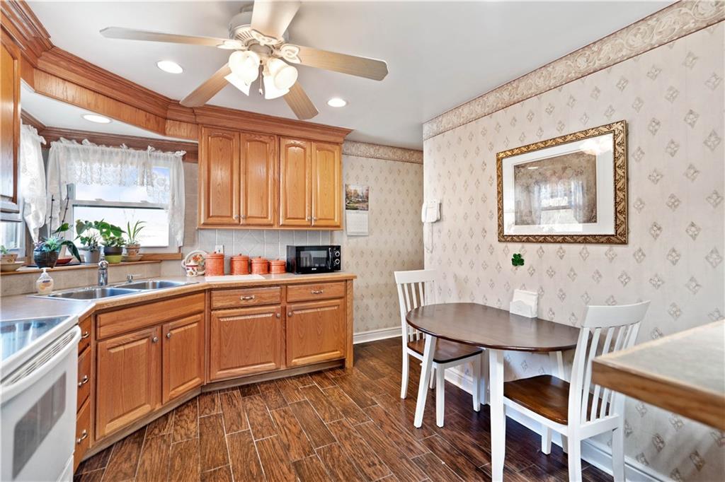 1007 Thermo Village Road New Stanton, PA 15672 - Photo 13 of 21 a kitchen with a dining table chairs cabinets and stainless steel appliances