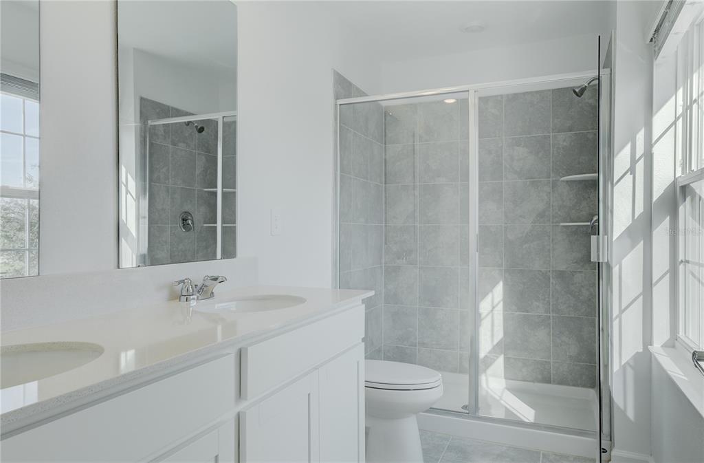 15627 Water Spring Boulevard Winter Garden, FL 34787 - Photo 32 of 45 a bathroom with a sink a toilet and shower