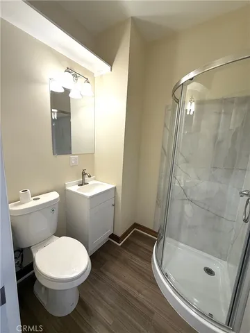 a bathroom with a glass door shower and a sink