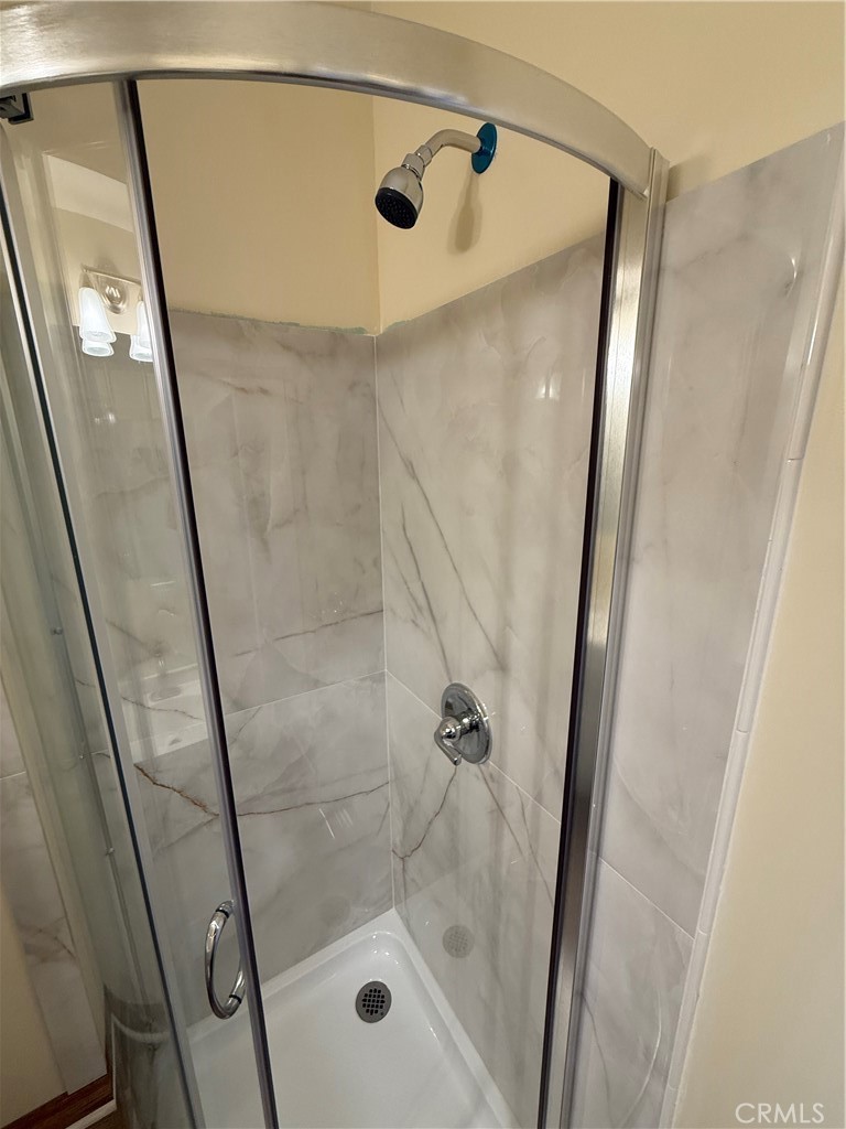 1944 New England Street Los Angeles, CA 90007 - Photo 14 of 18 a bathroom with a glass door shower and a sink