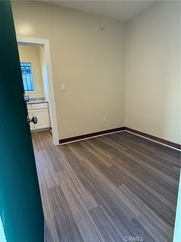 a view of a room with wooden floor