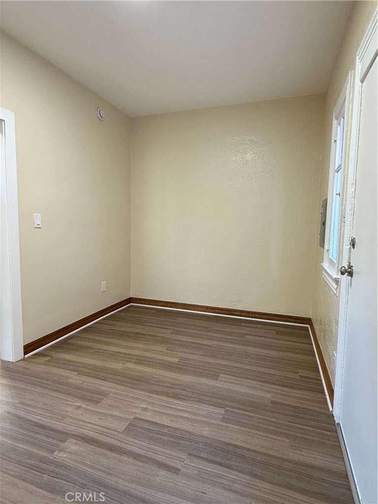 1944 New England Street Los Angeles, CA 90007 - Photo 4 of 18 a view of an empty room with wooden floor and a window