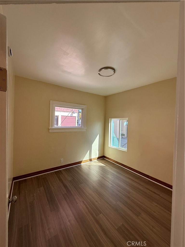 1944 New England Street Los Angeles, CA 90007 - Photo 10 of 18 an empty room with wooden floor and windows