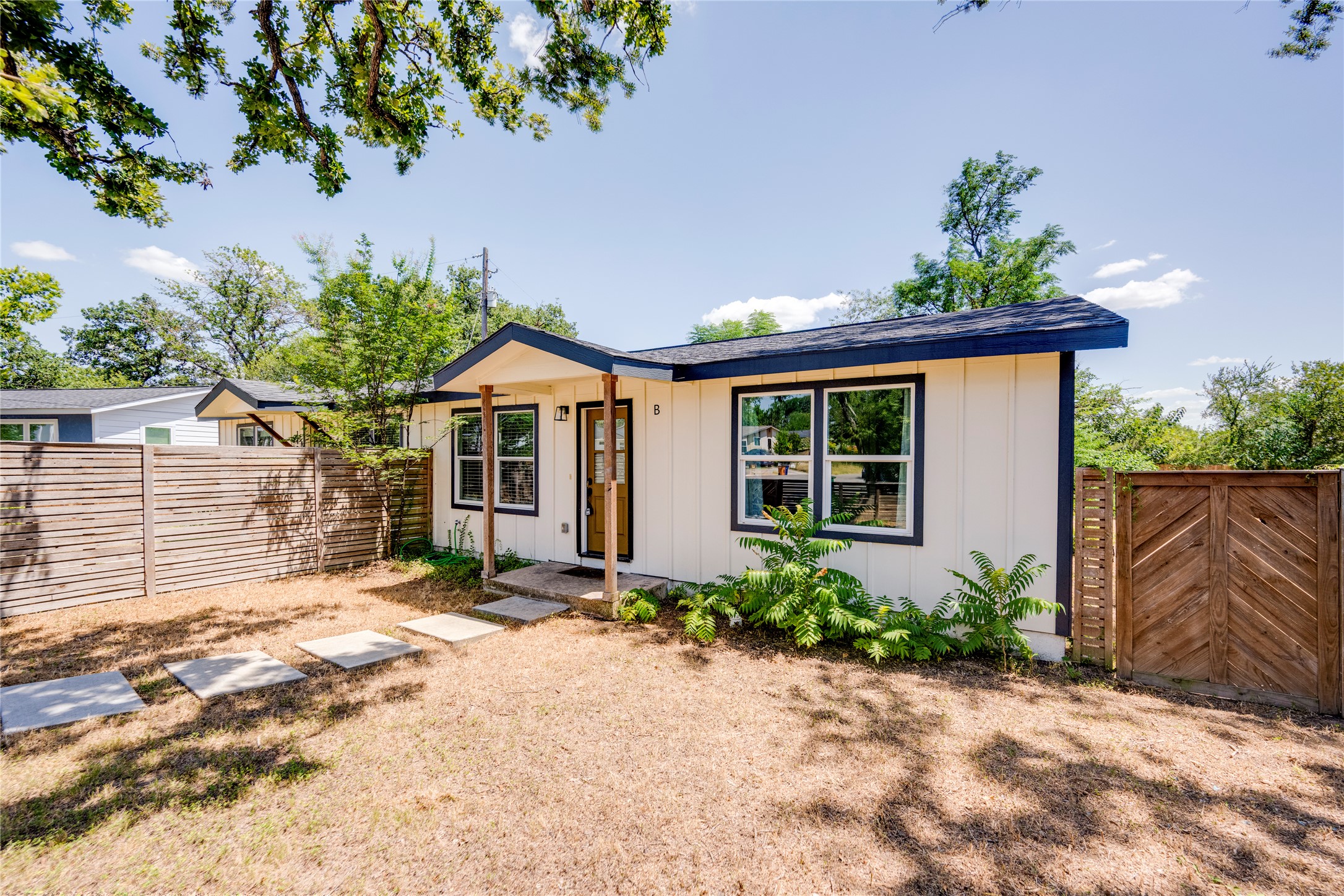 1400 Marcus Place, Unit B Austin, TX 78721 - Photo 1 of 39 A charming single-story residence with a welcoming front entrance and thoughtfully landscaped surroundings.