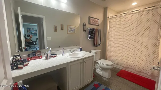 a bathroom with a sink toilet and shower