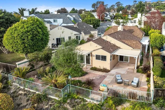 a front view of house with a garden