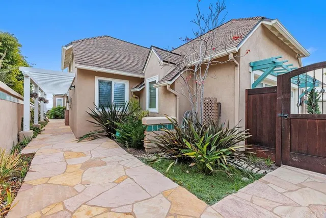 a view of a pathway of a house with flower plants