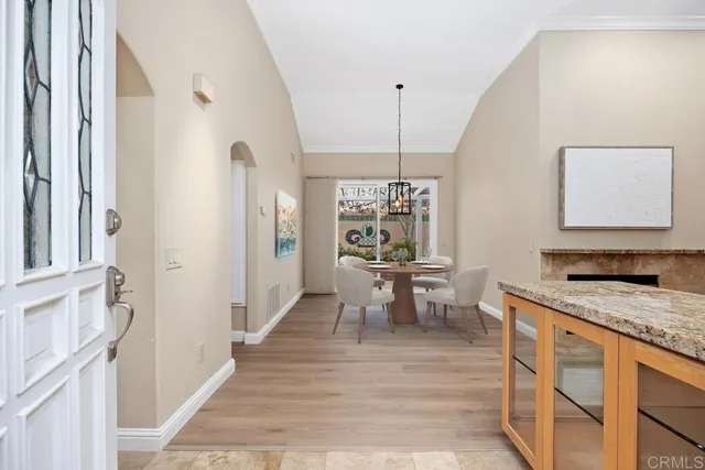 a living room with furniture a fireplace and a window