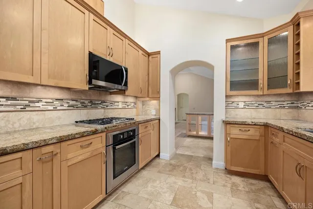 a kitchen with granite countertop a sink and cabinets