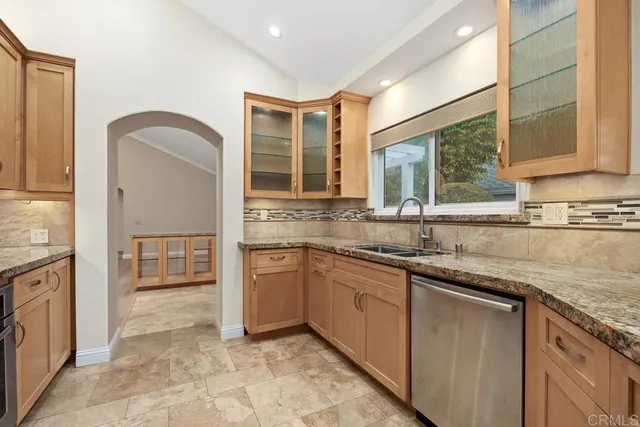 a kitchen with stainless steel appliances granite countertop a refrigerator and a sink