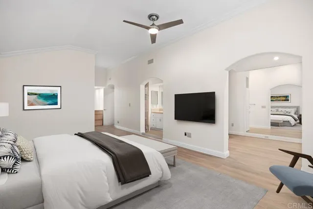 a bedroom with a bed and a flat tv screen on dresser