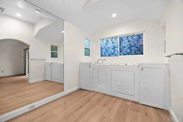 a bathroom with a granite countertop sink mirror and double