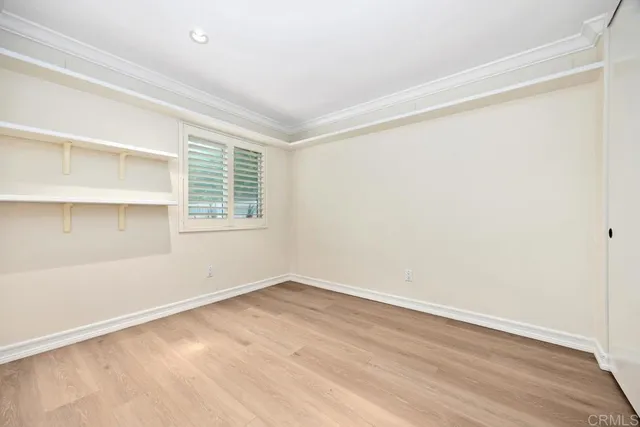 a view of an empty room with wooden floor