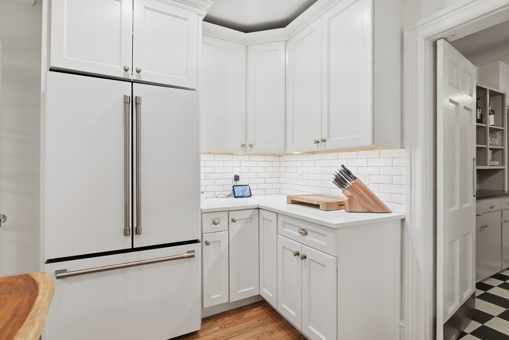 27 Lexington Avenue Holyoke, MA 01040 - Photo 12 of 42 a kitchen with white cabinets and white appliances