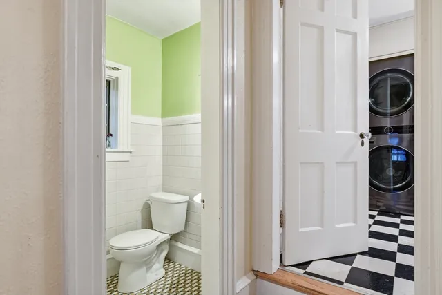 a bathroom with a toilet and a shower curtain