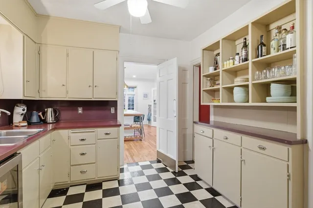 a kitchen with stainless steel appliances a stove a sink and a refrigerator