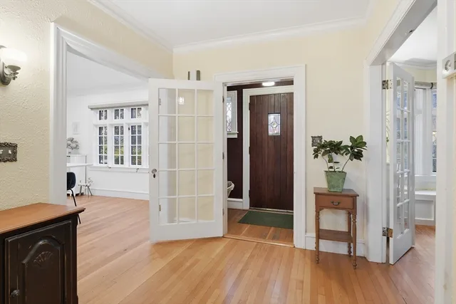 a view of an entryway with wooden floor and a livingroom