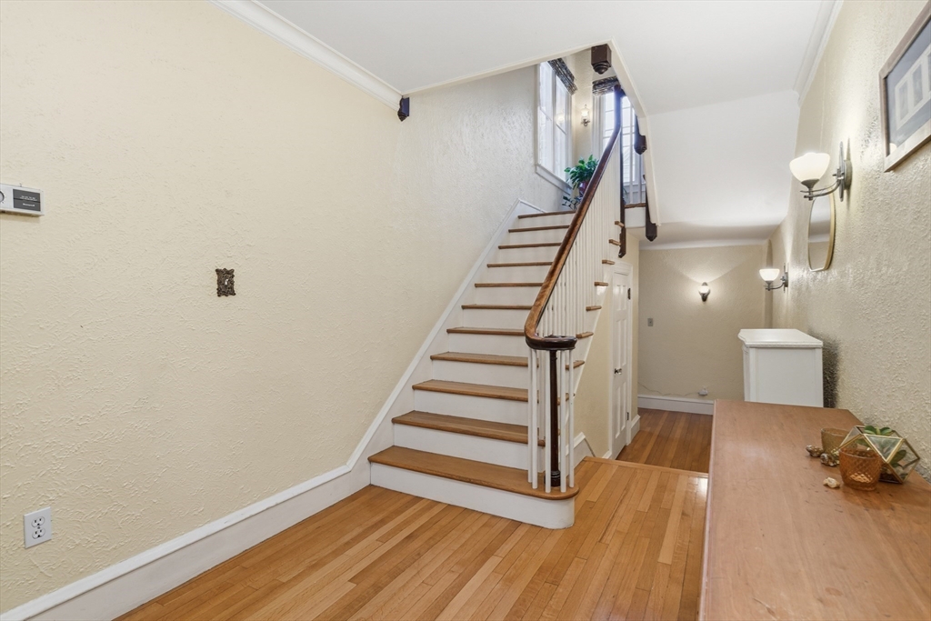 27 Lexington Avenue Holyoke, MA 01040 - Photo 17 of 42 a view of a room with wooden floor and stairs