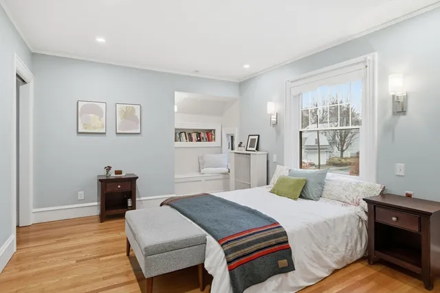 a bedroom with a bed and wooden floor