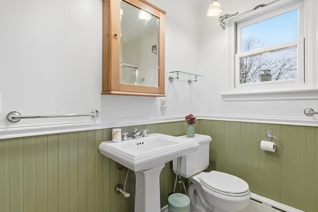 a bathroom with a sink mirror and toilet