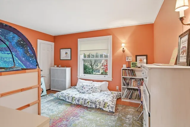 a bedroom with furniture and a book shelf