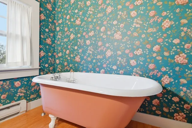 a bath tub sitting in a bathroom next to a window
