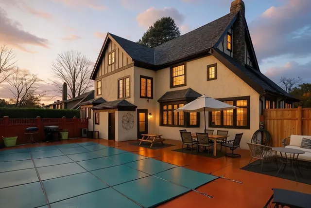 a view of a house with swimming pool and sitting area
