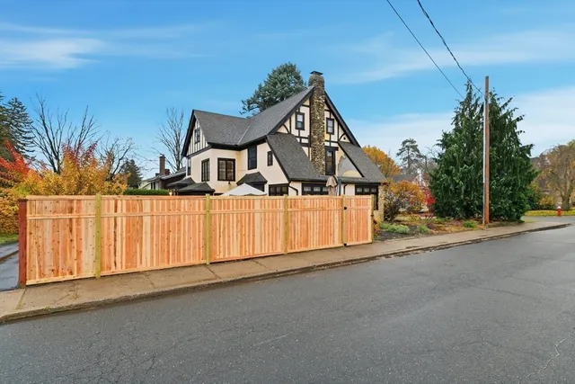 a view of a house with a wooden fence