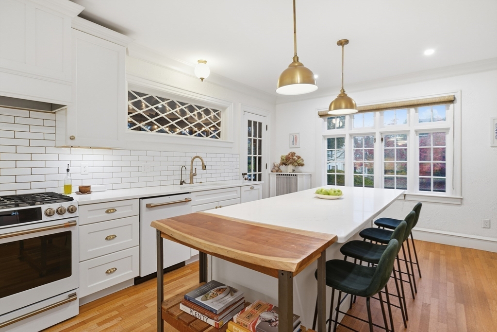 27 Lexington Avenue Holyoke, MA 01040 - Photo 4 of 42 a kitchen that has a table chairs and a stove