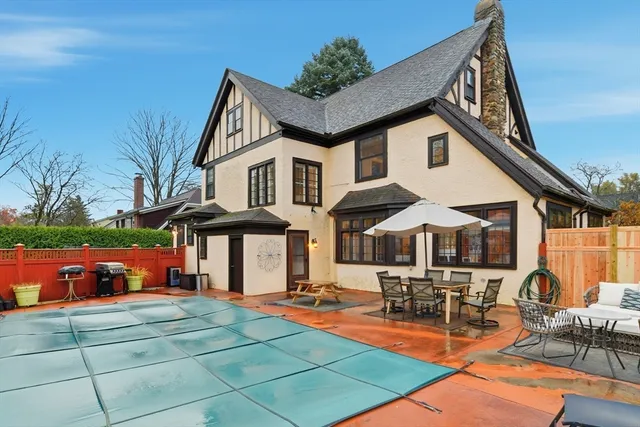 a patio with a table and chairs under an umbrella