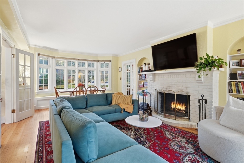 27 Lexington Avenue Holyoke, MA 01040 - Photo 6 of 42 a living room with furniture a flat screen tv and a fireplace