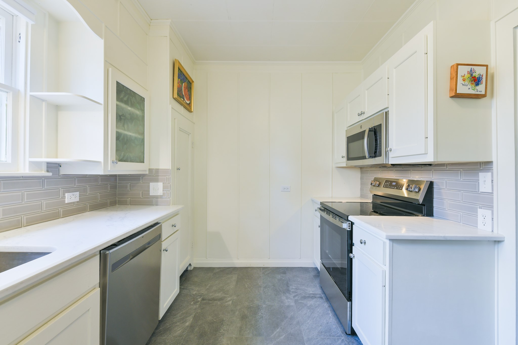 802 South Day Street Brenham, TX 77833 - Photo 32 of 50 a kitchen with stainless steel appliances granite countertop a sink stove and microwave