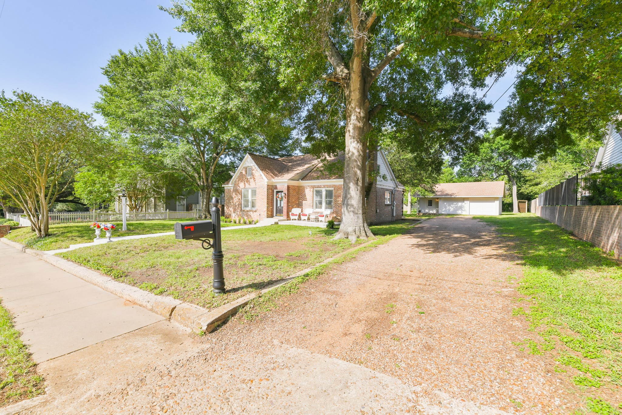 802 South Day Street Brenham, TX 77833 - Photo 4 of 50 a view of a white house with a yard