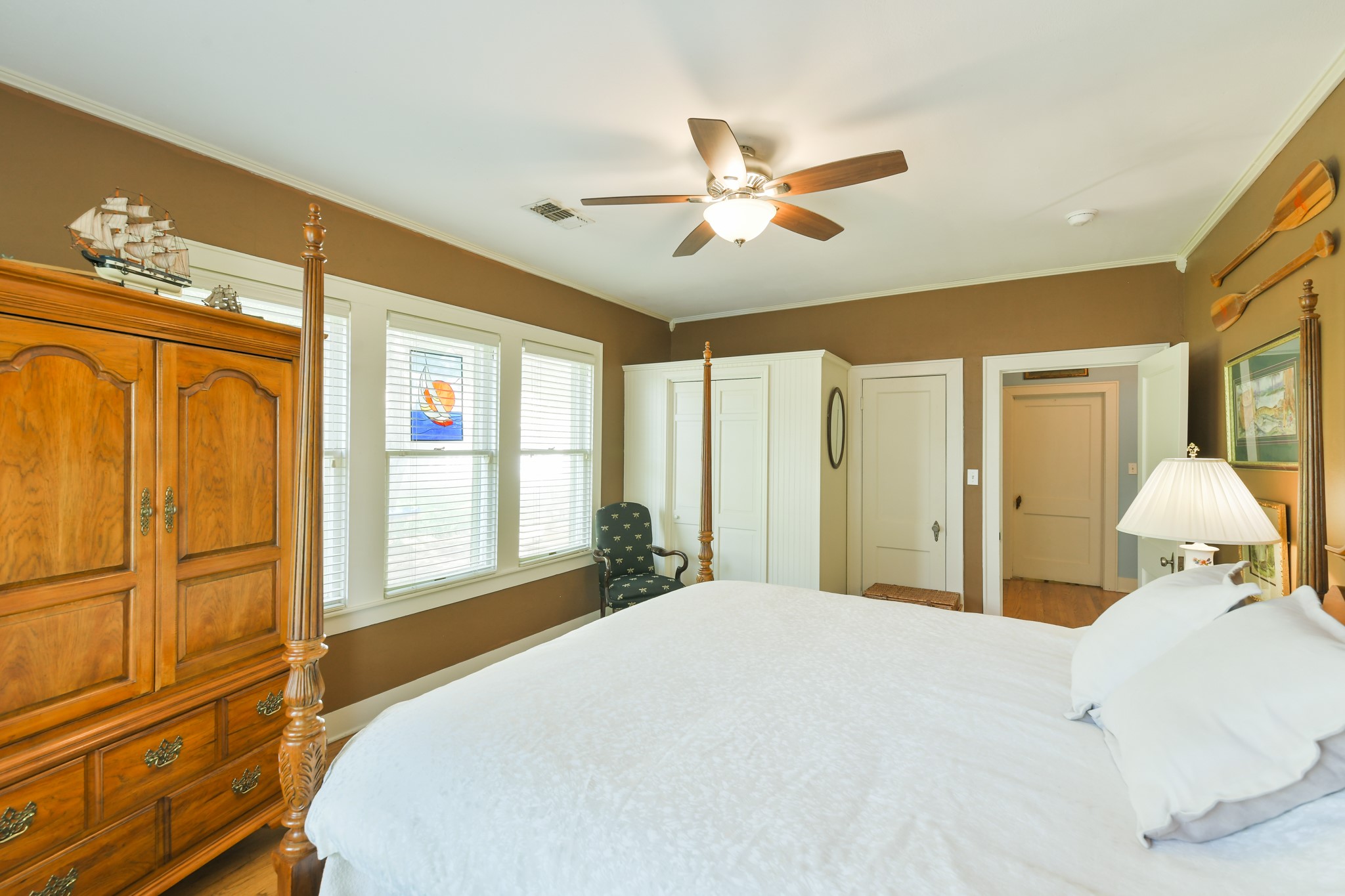 802 South Day Street Brenham, TX 77833 - Photo 44 of 50 a bedroom with a large bed and a chandelier